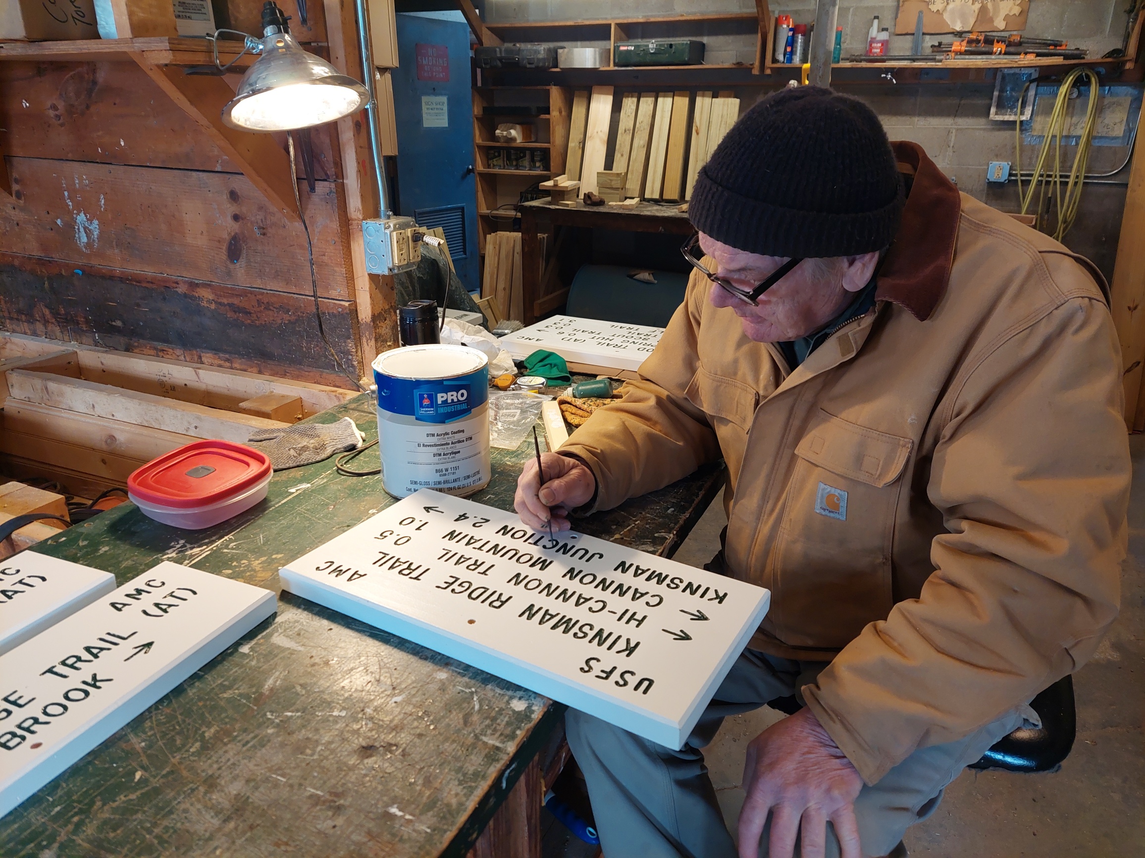 George Brown hard at work making a trail sign in a workshop next to AMC’s Pinkham Notch Visitors Center.